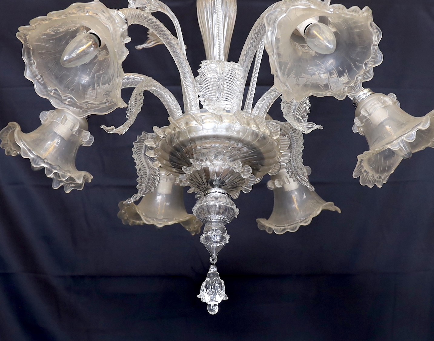 A Venetian clear glass six light chandelier with ornate foliage and flower motifs, height 85cm. width 74cm